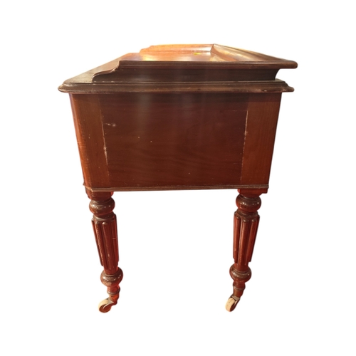 117 - A Victorian mahogany writing desk with 5 drawers & frieze top on reeded turned legs 120cm wide.