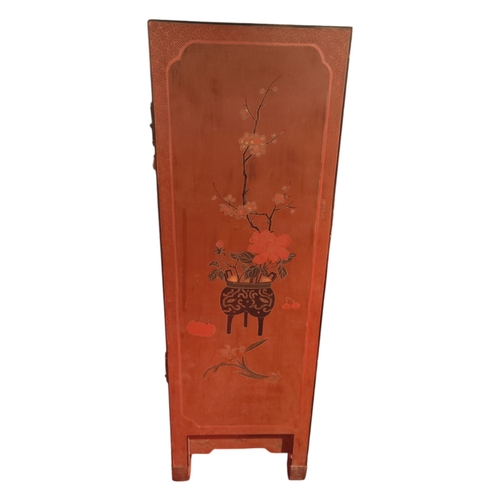 120 - A lacquered Chinese 2 door cabinet with floral decorations 94cm high 64cm wide.