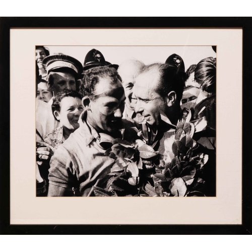 107 - Two monochrome studies of Fangio (2) A pair of monochrome studies of Fangio, one in usual guise behi... 