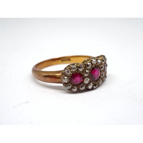 360 - A triple cluster ring comprising three brilliant cut red stones surrounded by interlinked haloes of ... 