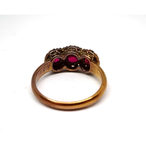 360 - A triple cluster ring comprising three brilliant cut red stones surrounded by interlinked haloes of ... 