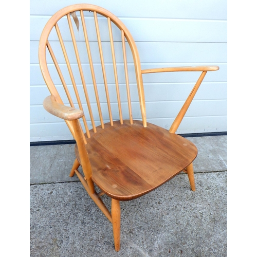 558 - A blonde Ercol low armchair