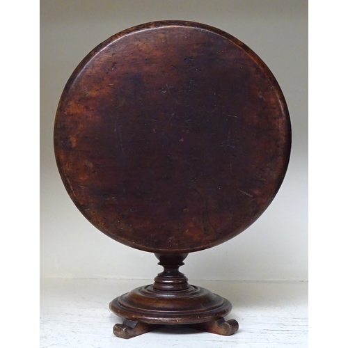 145 - A miniature circular tilt top table