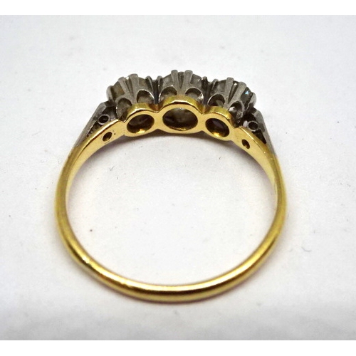 368 - A trilogy ring comprising three brilliant cut white stones in a white metal raised claw setting on a... 