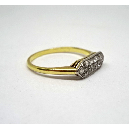 370 - A ring constituting ten brilliant cut white stones in an elongated hexagonal yellow metal head on a ... 