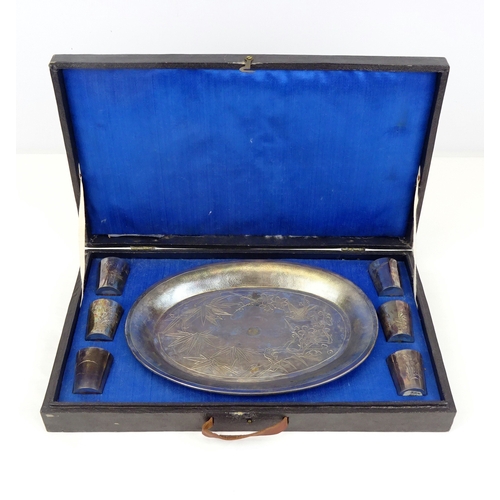 443 - A Chinese white metal oval tray with six matching cups, cased.