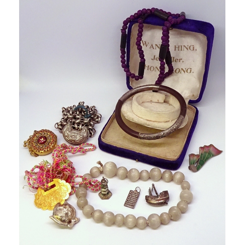 445 - A Moonstone bead bracelet, an oriental white metal and hardwood bangle, white metal charms etc.