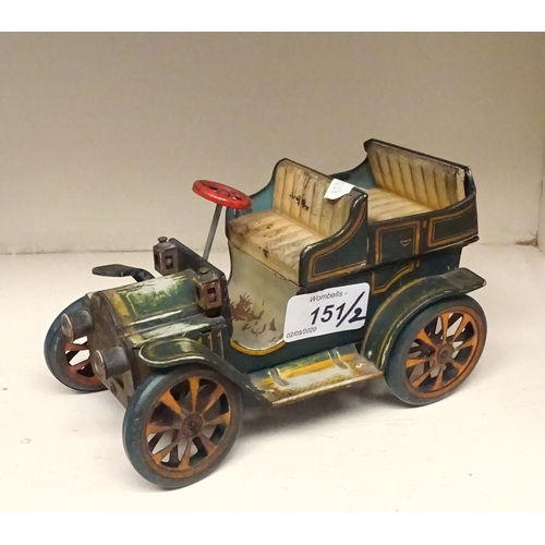 151 - A Schuco tinplate model Renault 1230 in partial box; a Japanese tinplate toy car. (2)