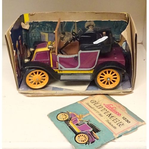 151 - A Schuco tinplate model Renault 1230 in partial box; a Japanese tinplate toy car. (2)