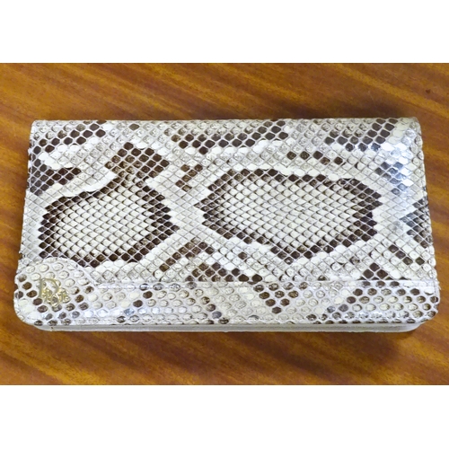 165 - A clutch bag bearing applied gilt motif 