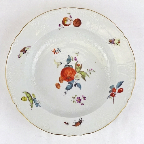 203 - A Meissen soup dish having fruit and insect painted decoration on a molded body, a/f chip to rim; an... 