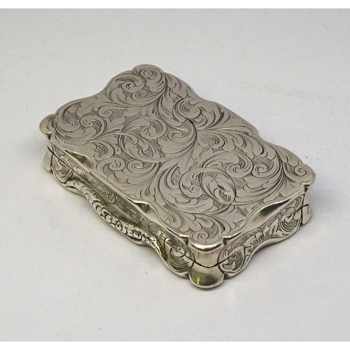 452 - A snuff box, silver having wavy edges and engraved foliate decoration incorporating a monogram SJ (?... 