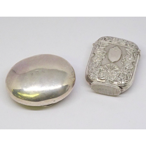 354 - A snuff box and a vesta case, continental white metal.  Snuff box 49 x 40mm oval.  (2)