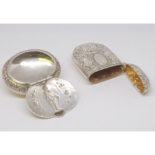 354 - A snuff box and a vesta case, continental white metal.  Snuff box 49 x 40mm oval.  (2)