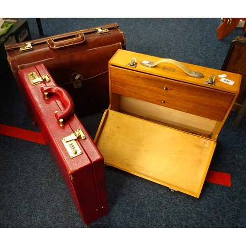 398 - A leather briefcase, together with another leather case and a watchmakers case. (3)