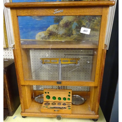 401 - A cased Apocrathy set of scales together with some weights.