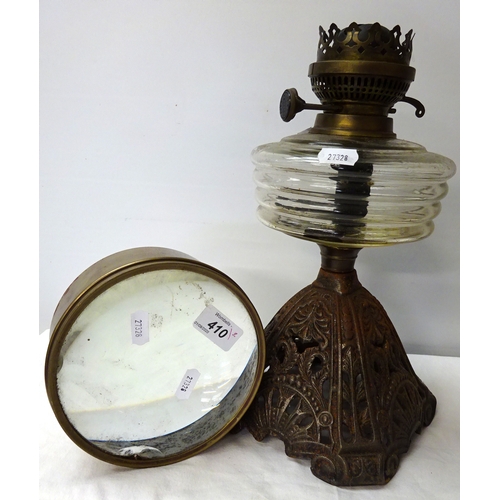 410 - An oil lamp base together with a large magnifying glass.