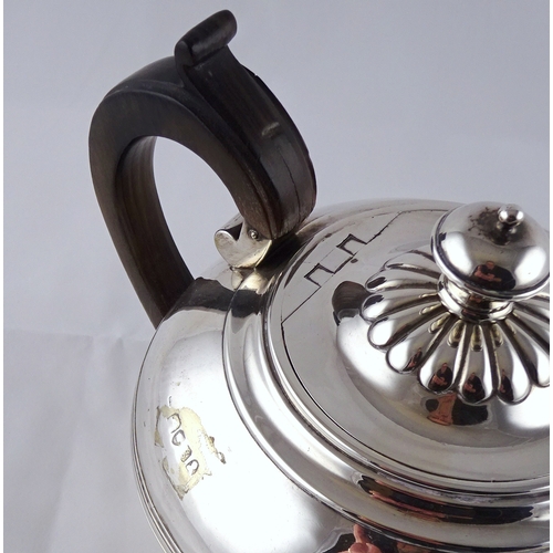 13 - A George IV silver tea pot having rosewood handle, London 1822, sponsors mark rubbed.  670gr gross /... 