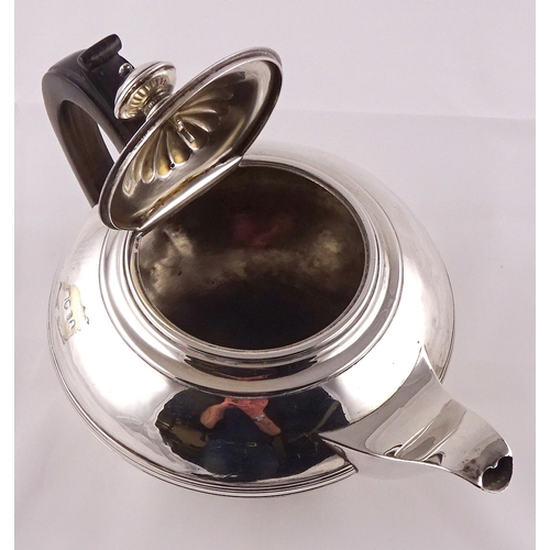 13 - A George IV silver tea pot having rosewood handle, London 1822, sponsors mark rubbed.  670gr gross /... 