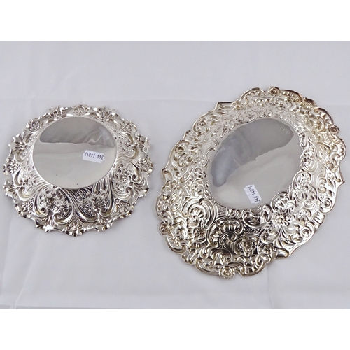 19 - A late Victorian oval silver dish having repousse decoration; a similar circular dish.  Oval dish 26... 