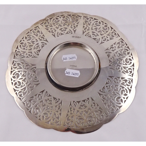 20 - A circular silver plate having waved edge and pierced border, the whole on a circular foot, early 20... 