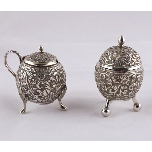 22 - A teapot having raised and chased decoration, Anglo-Thai / Siam white metal, approximately 200mm han... 