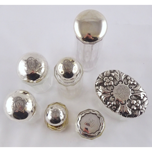 45 - Seven various silver topped glass dressing set flasks.  Tallest 185mm (by instruction of the family ... 