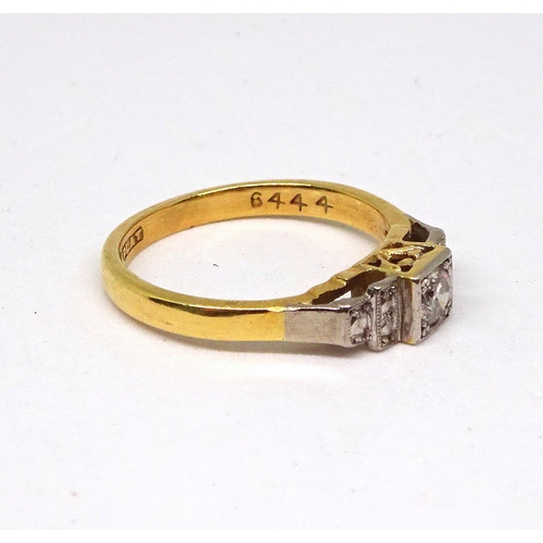 100 - A ring comprising a single brilliant cut white stone set in a square setting with raised, stone set ... 