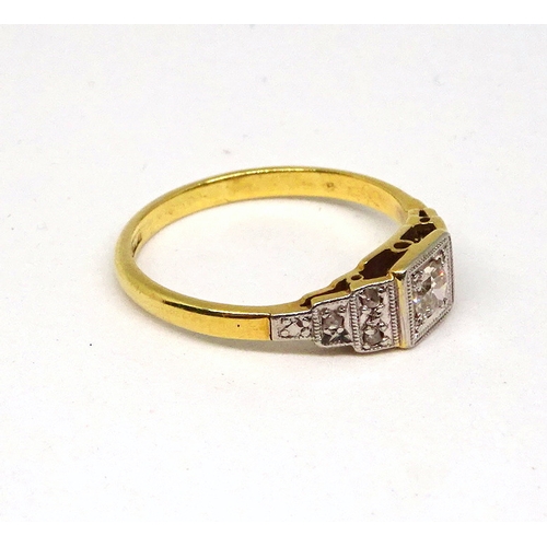 101 - A ring comprising a single brilliant cut white stone set in a square setting with raised, stone set ... 