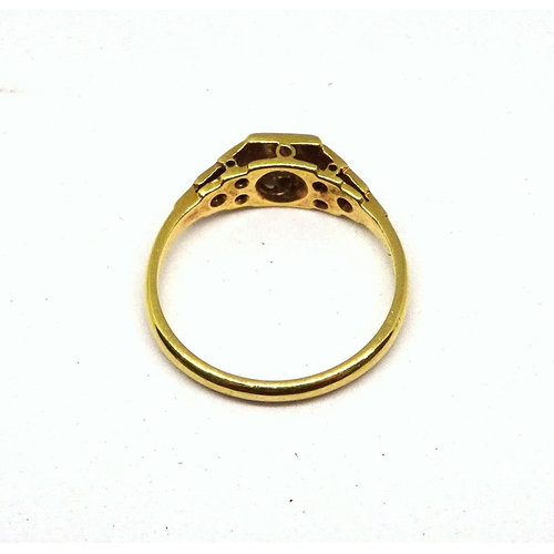 101 - A ring comprising a single brilliant cut white stone set in a square setting with raised, stone set ... 
