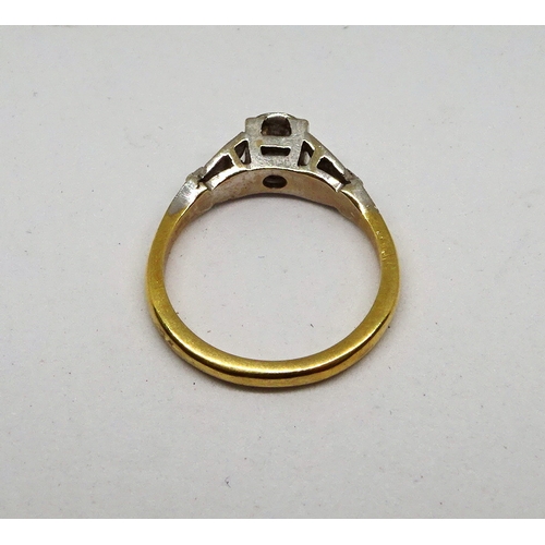 102 - A ring comprising a single brilliant cut white stone set in a circular setting within a square shape... 