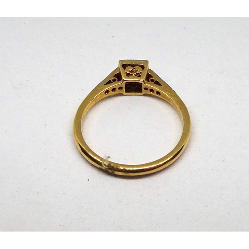 103 - A ring comprising a single brilliant cut white stone set in a square setting with stone set shoulder... 