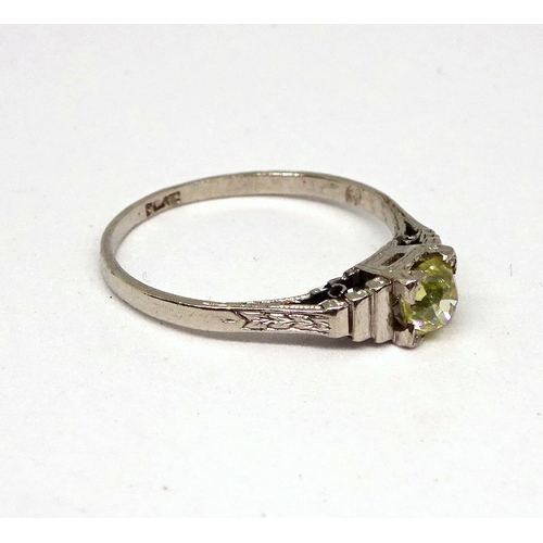 106 - A ring comprising a single brilliant cut stone with a pale yellow cast set in a square setting with ... 