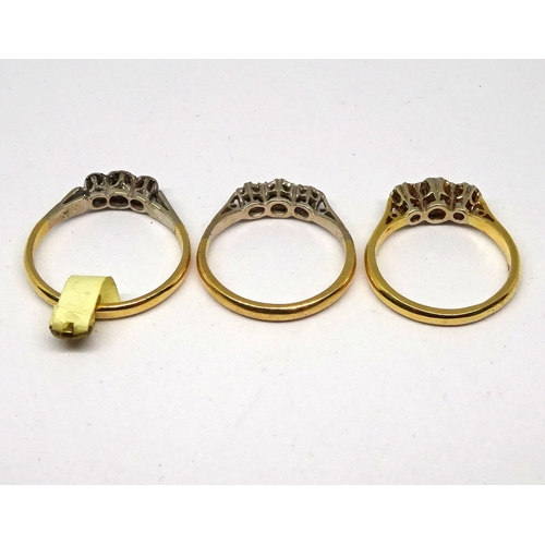 111 - Three trilogy rings comprising small white stones in yellow and white metal settings marked 18ct & P... 