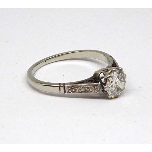 113 - A ring comprising a brilliant cut white stone in a raised claw setting with stone set shoulders, unm... 