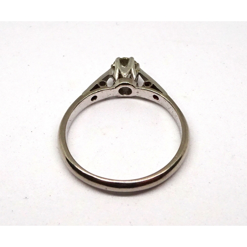 114 - A ring comprising a single brilliant cut white stone in a raised claw setting with stone set shoulde... 