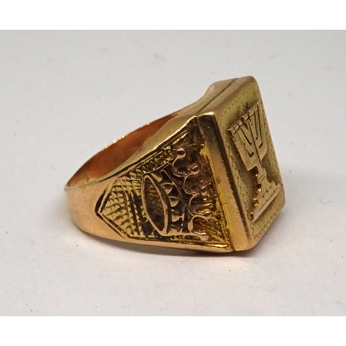 119 - A signet ring, the rectangular head bearing a menorah motif design, the shoulders bearing crown desi... 