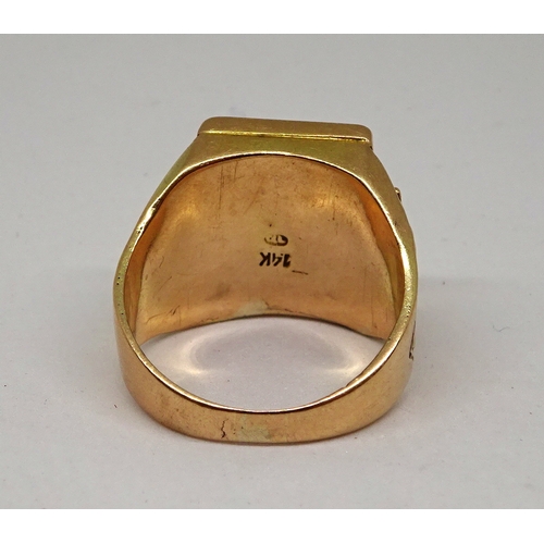 119 - A signet ring, the rectangular head bearing a menorah motif design, the shoulders bearing crown desi... 