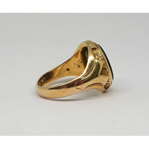 122 - A signet ring comprising a polished onyx stone in an oval 15ct gold carved setting, stone rubbed.  1... 