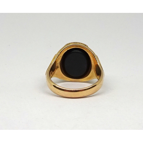 122 - A signet ring comprising a polished onyx stone in an oval 15ct gold carved setting, stone rubbed.  1... 