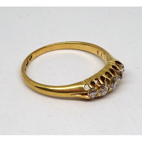 132 - A ring comprising five graduated brilliant cut white stones in a raised claw setting, 18ct gold.  3g... 