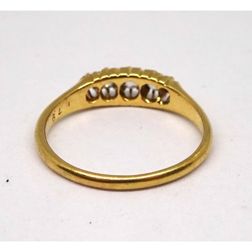 132 - A ring comprising five graduated brilliant cut white stones in a raised claw setting, 18ct gold.  3g... 