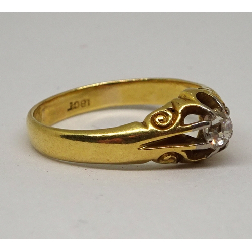 140 - A gentleman's solitaire ring comprising an old cut white stone in a part carved claw setting, yellow... 