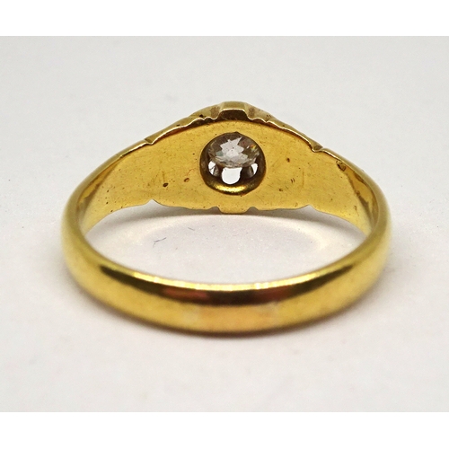140 - A gentleman's solitaire ring comprising an old cut white stone in a part carved claw setting, yellow... 