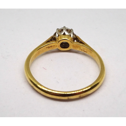 149 - A solitaire ring comprising a brilliant cut white stone in a white metal claw setting on a yellow me... 