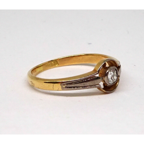 159 - A solitaire ring comprising a cushion shaped old cut white stone in a rub-over setting within a 