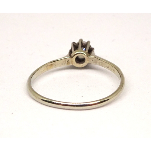 162 - A solitaire ring comprising a brilliant cut white stone in a raised claw setting, unmarked white met... 