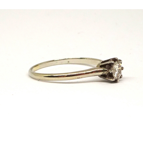 162 - A solitaire ring comprising a brilliant cut white stone in a raised claw setting, unmarked white met... 