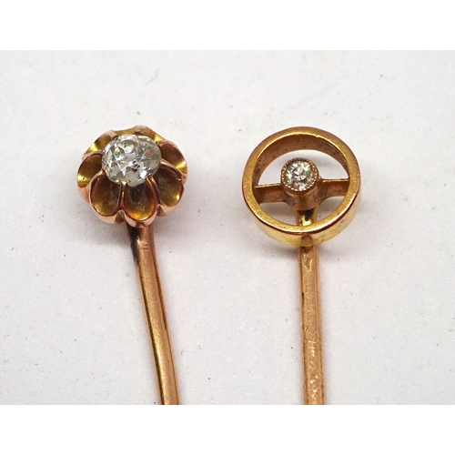 175 - A stick pin having a cluster head comprising ten old cut white stones around a central red stone, he... 