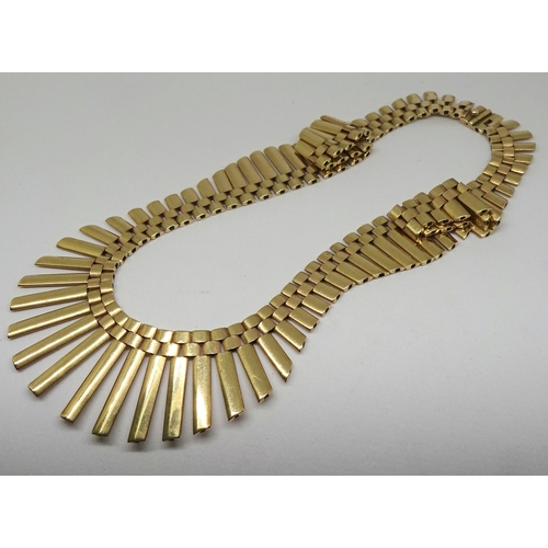 80 - A fringe necklace of waved design, plain polished links, 9ct gold.  435mm long / 28mm max. depth / 5... 